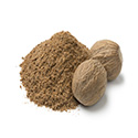 Nutmeg seeds next to ground nutmeg